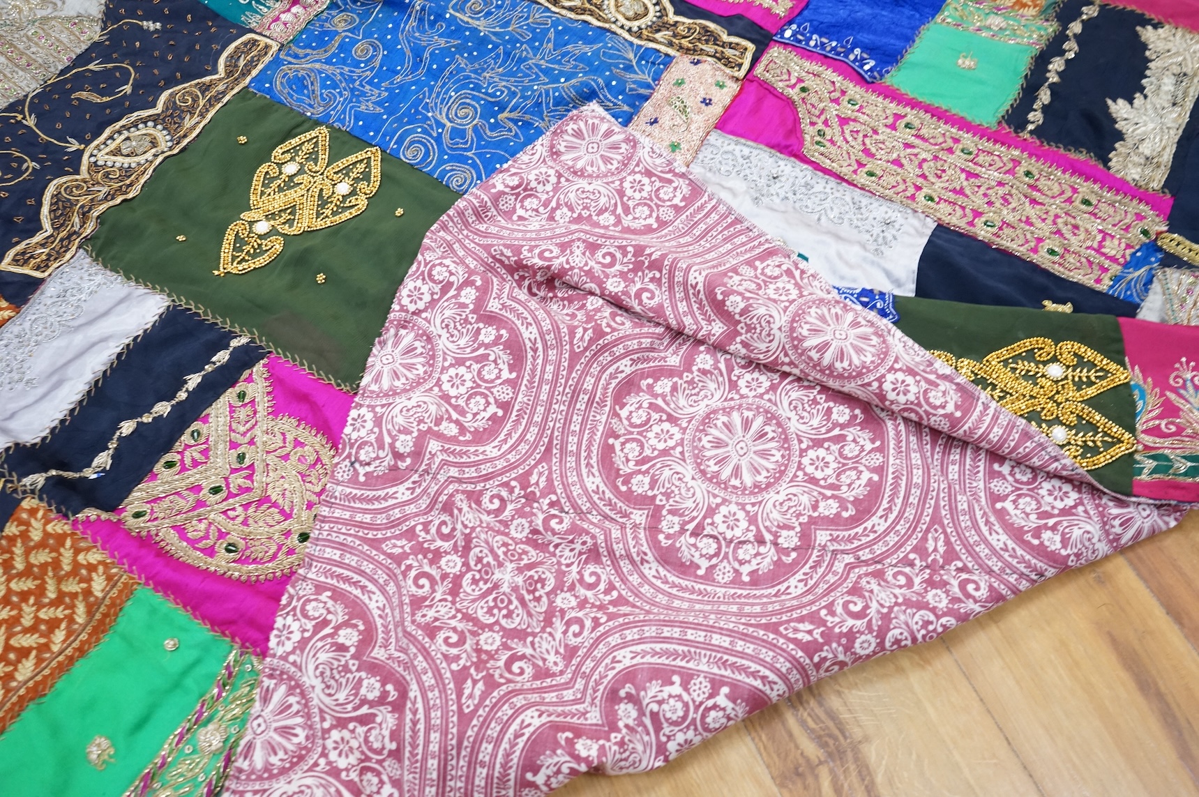 A quantity of mostly 20th century Middle Eastern and Indian woven and printed textiles and a peacock feather fan (2 boxes).